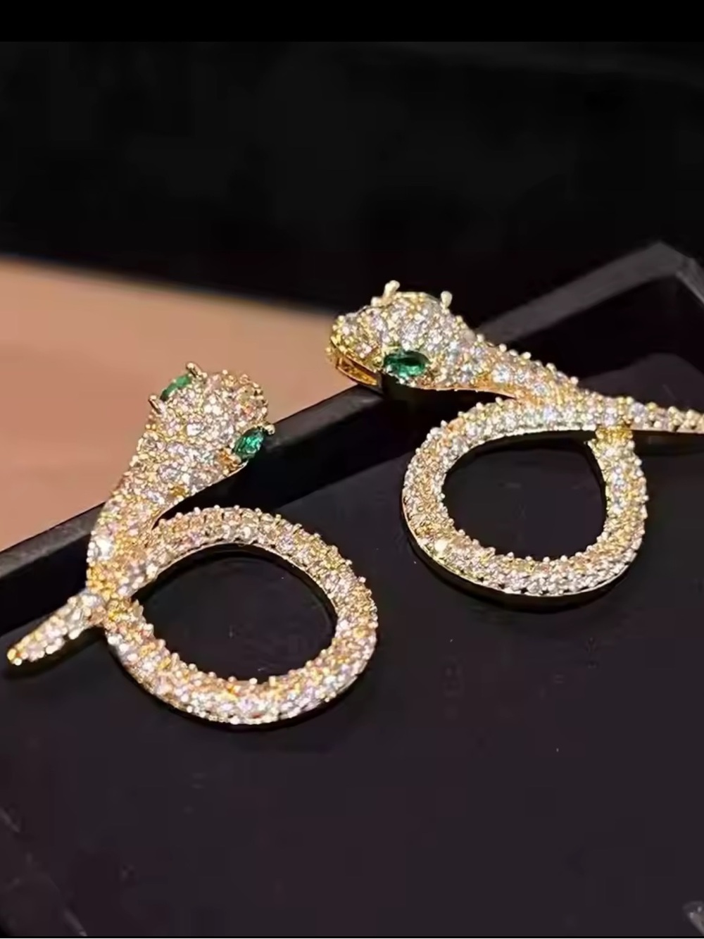 Gold Crystal Snake Earrings with Green Accent